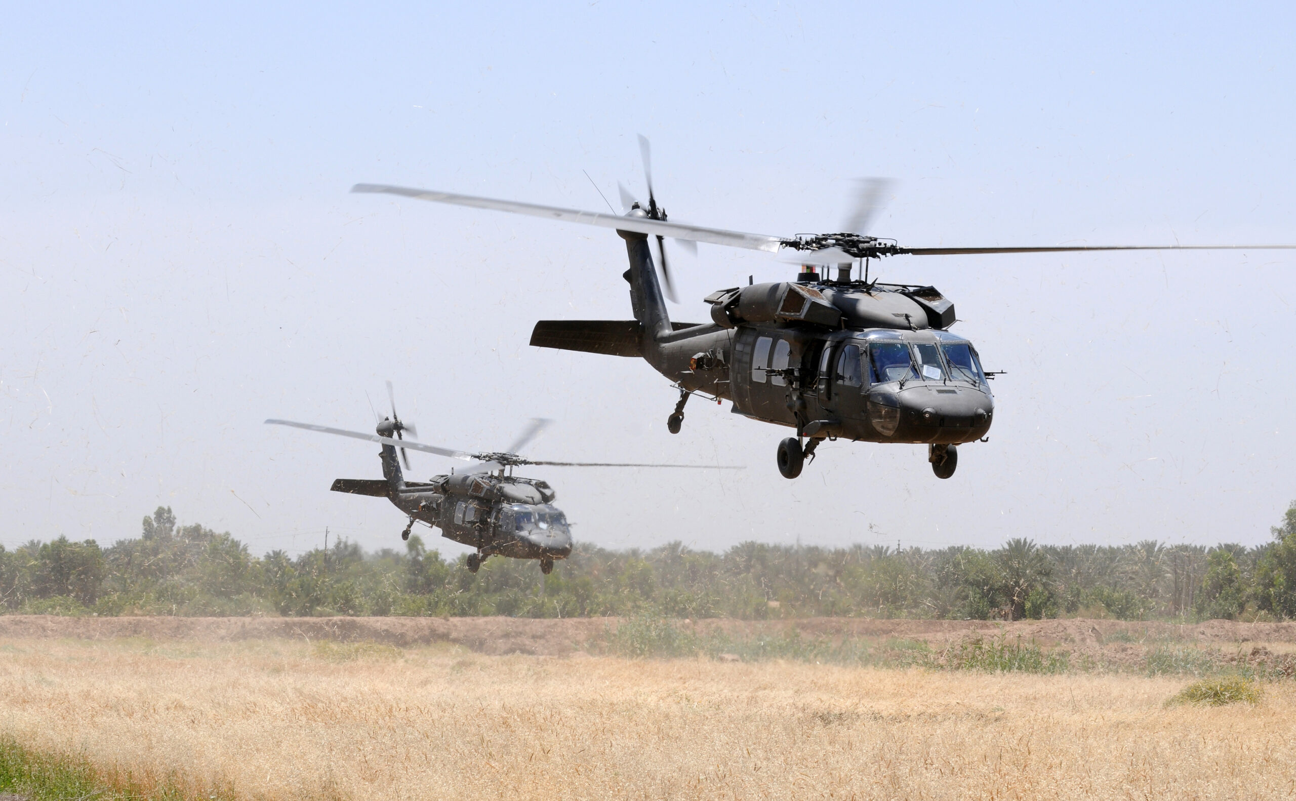 two assault helicopters in operation